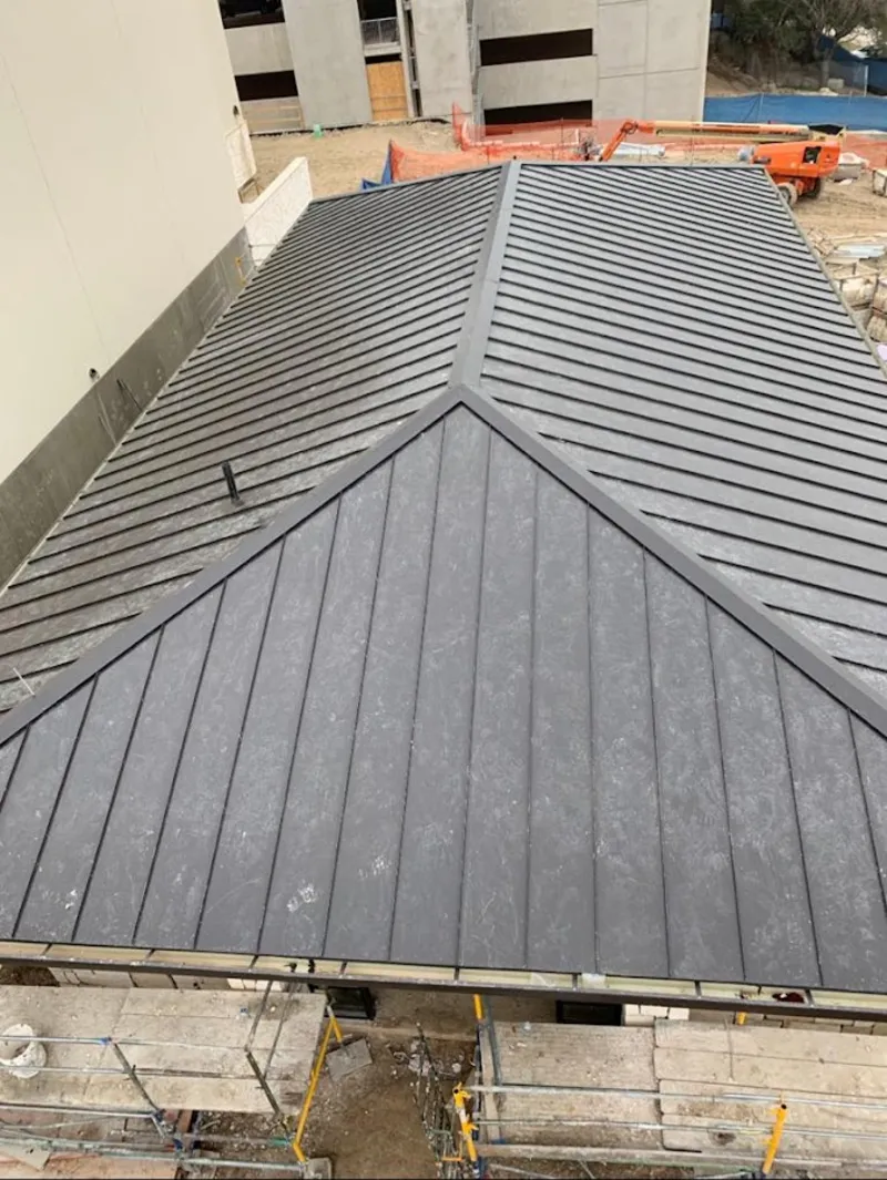 Commercial metal roof construction with crane equipment in Parkwood