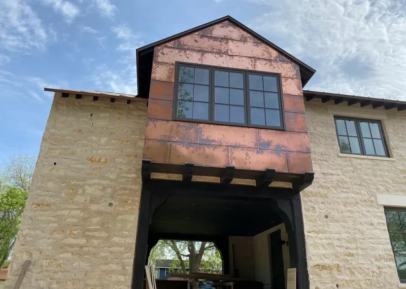 Copper metal panel facade on a stone building for Skylight Installation in Parkwood